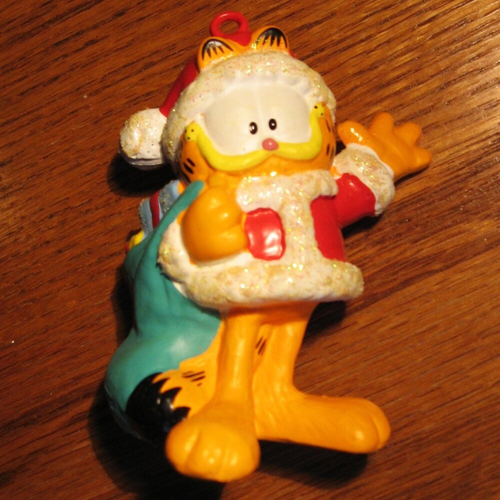 Garfield Christmas Ornament with gift sack draped over back, made by Heirloom
